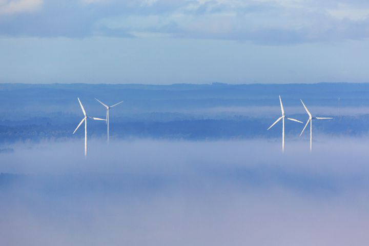 Wind powers in misty countryside landscape